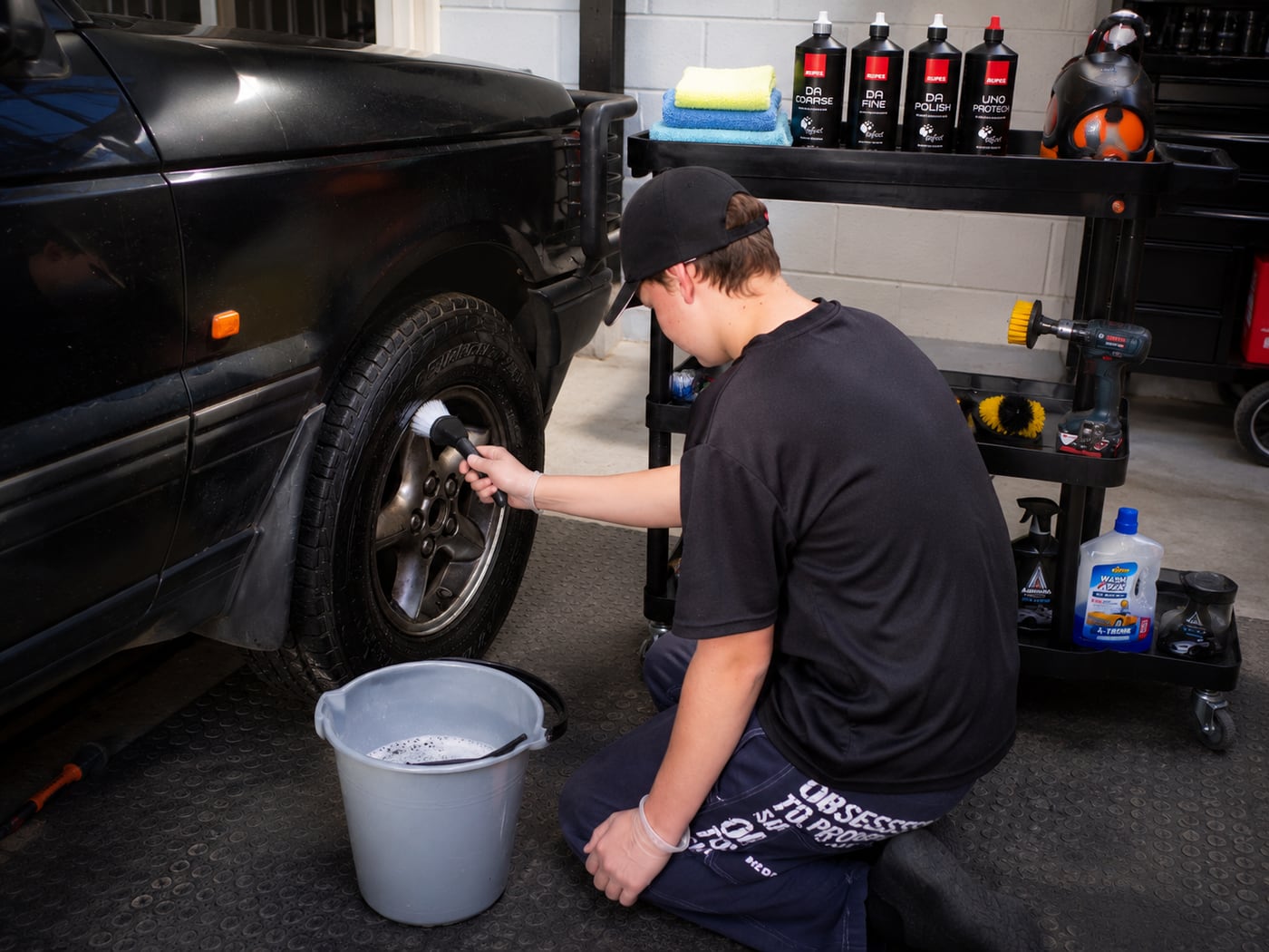 Detail My Car ZA detailer hand-cleaning a wheel with professional detailing products and tools, Johannesburg North