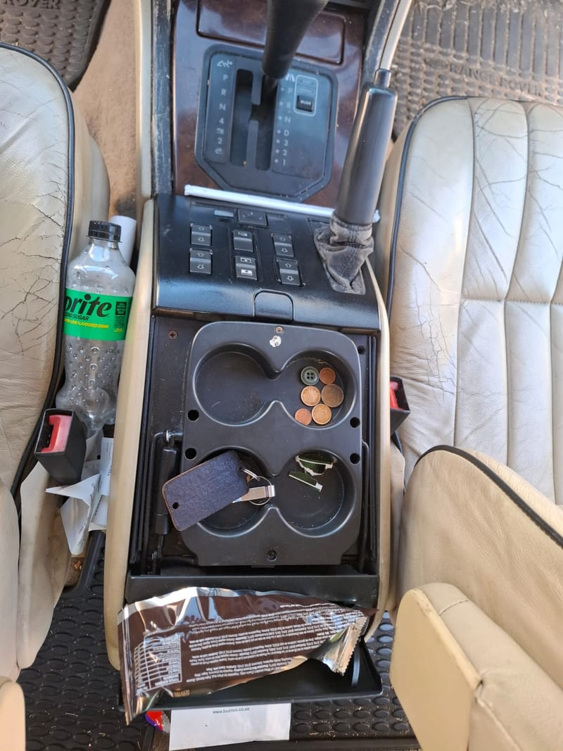 Car centre console before detailing — cluttered and grimy, Johannesburg North